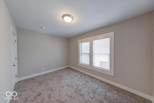 420 Eastern Ave, Indianapolis, IN 46201 - carpeted empty room with baseboards and a textured ceiling