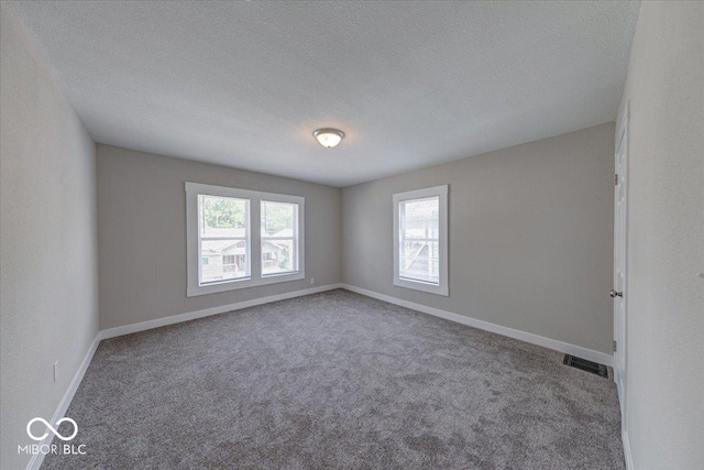 420 Eastern Ave, Indianapolis, IN 46201 - carpeted spare room featuring a textured ceiling and baseboards