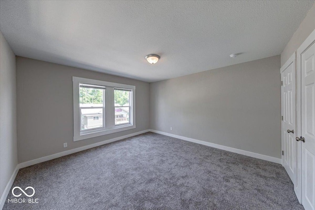 420 Eastern Ave, Indianapolis, IN 46201 - carpeted spare room featuring a textured ceiling and baseboards