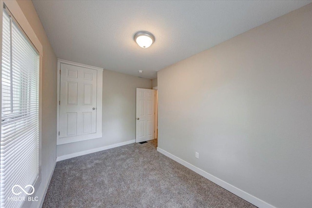 420 Eastern Ave, Indianapolis, IN 46201 - unfurnished bedroom featuring carpet flooring and a textured ceiling