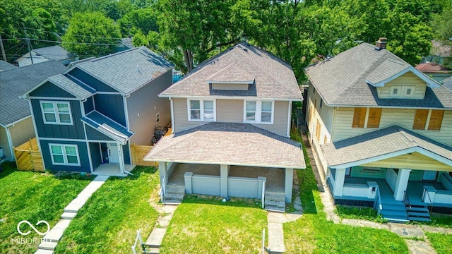 420 Eastern Ave, Indianapolis, IN 46201 - view of front of property with board and batten siding, covered porch, and a front yard