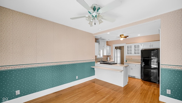 753 Walnut St, Franklin, IN 46131 - kitchen featuring freestanding refrigerator, wallpapered walls, light wood finished floors, ceiling fan, and white cabinets
