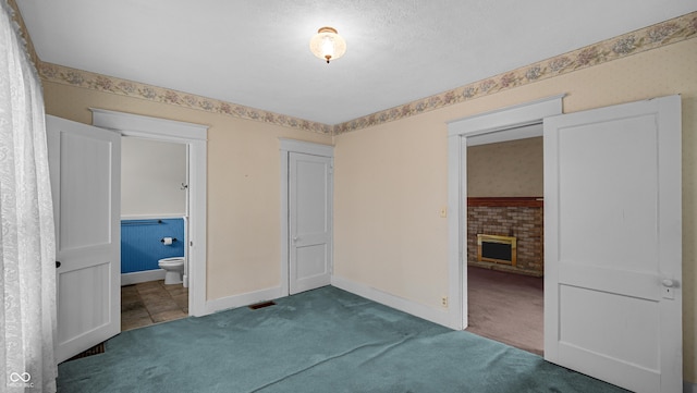 753 Walnut St, Franklin, IN 46131 - unfurnished bedroom with carpet floors, a fireplace, and ensuite bath
