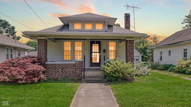 753 Walnut St, Franklin, IN 46131 - bungalow-style home with covered porch, a lawn, brick siding, and a chimney