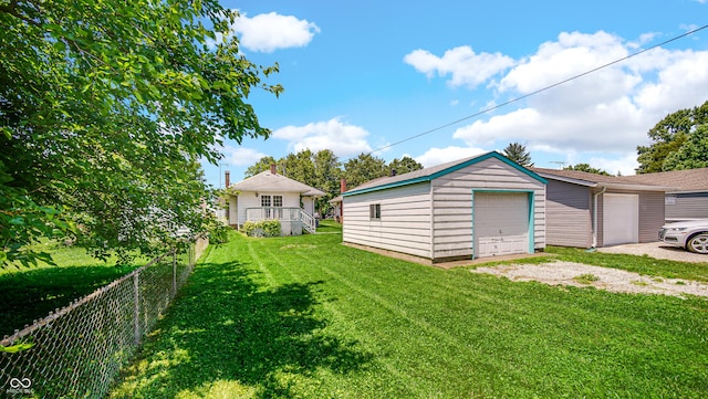 753 Walnut St, Franklin, IN 46131 - view of yard featuring an outdoor structure, a garage, and driveway