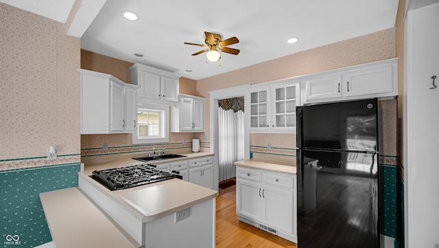 753 Walnut St, Franklin, IN 46131 - kitchen featuring freestanding refrigerator, wallpapered walls, white cabinets, a ceiling fan, and light countertops