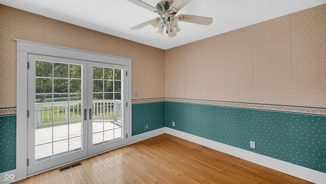 753 Walnut St, Franklin, IN 46131 - empty room with wood-type flooring, wallpapered walls, french doors, and a ceiling fan