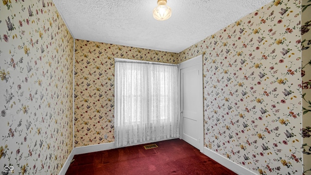 753 Walnut St, Franklin, IN 46131 - spare room featuring a textured ceiling, wallpapered walls, and carpet