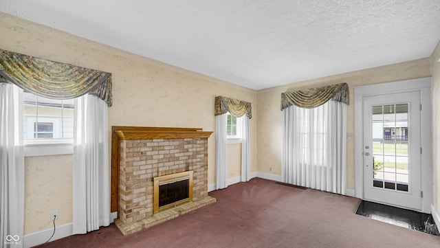 753 Walnut St, Franklin, IN 46131 - unfurnished living room with carpet floors, a textured ceiling, a brick fireplace, and wallpapered walls