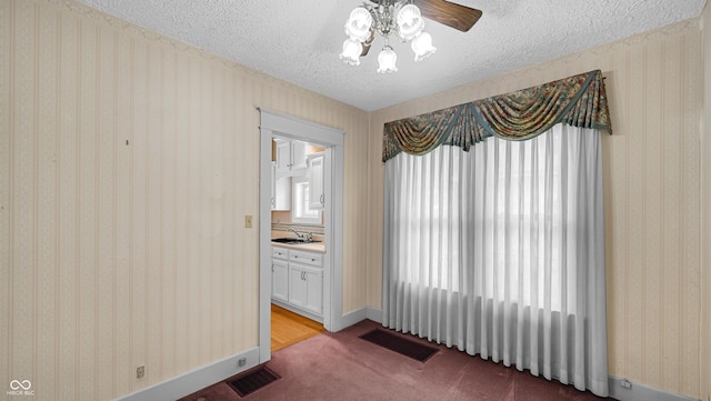 753 Walnut St, Franklin, IN 46131 - unfurnished dining area featuring a textured ceiling, a ceiling fan, carpet floors, and plenty of natural light