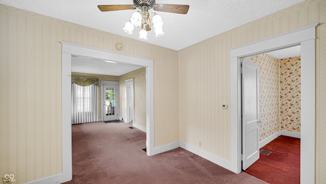 753 Walnut St, Franklin, IN 46131 - carpeted spare room with a ceiling fan, a textured ceiling, wallpapered walls, and a smoke detector