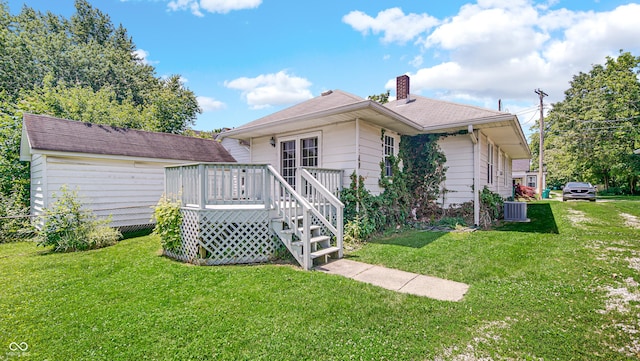 753 Walnut St, Franklin, IN 46131 - rear view of house with a deck, a yard, a chimney, and a shingled roof