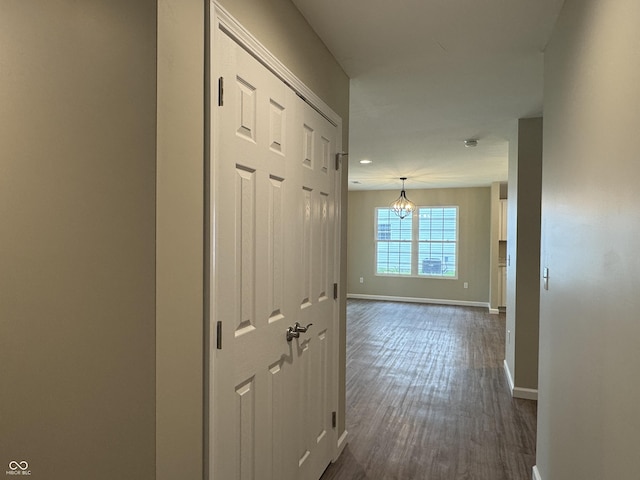 177 W Itawamba Trl, Greensburg, IN 47240 - hall featuring baseboards, dark wood-style flooring, and a chandelier