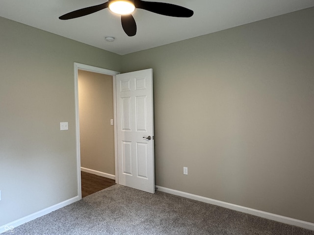 177 W Itawamba Trl, Greensburg, IN 47240 - unfurnished bedroom featuring dark colored carpet, baseboards, and ceiling fan