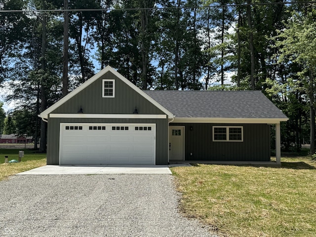 177 W Itawamba Trl, Greensburg, IN 47240 - view of front facade with gravel driveway, a front lawn, a garage, and a shingled roof