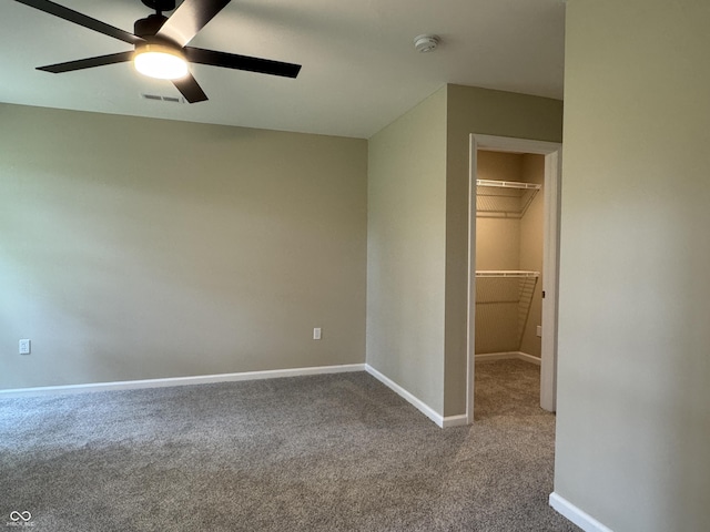 177 W Itawamba Trl, Greensburg, IN 47240 - unfurnished bedroom with a walk in closet, carpet flooring, baseboards, a closet, and ceiling fan
