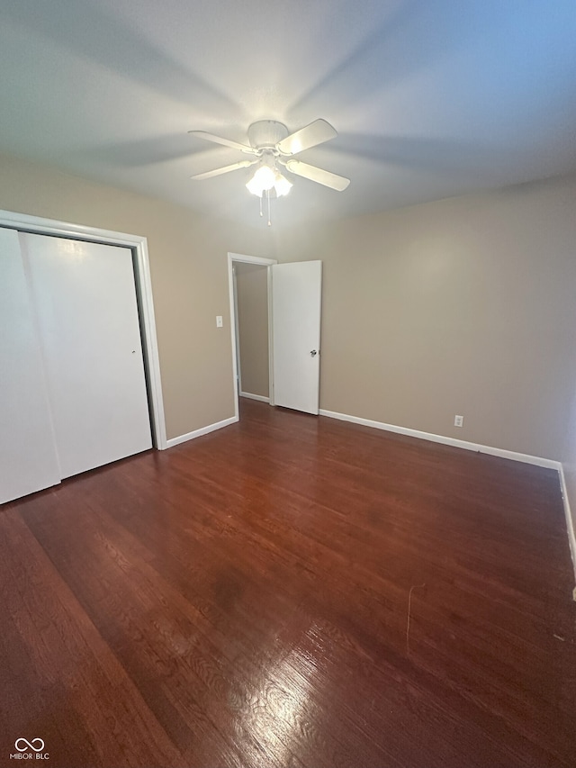 2180 N Irwin St, Indianapolis, IN 46219 - unfurnished bedroom featuring wood finished floors, baseboards, ceiling fan, and a closet