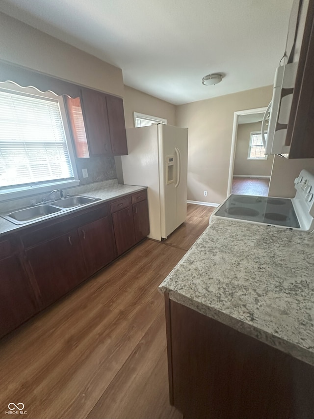 2180 N Irwin St, Indianapolis, IN 46219 - kitchen with white appliances, a sink, wood finished floors, and light countertops