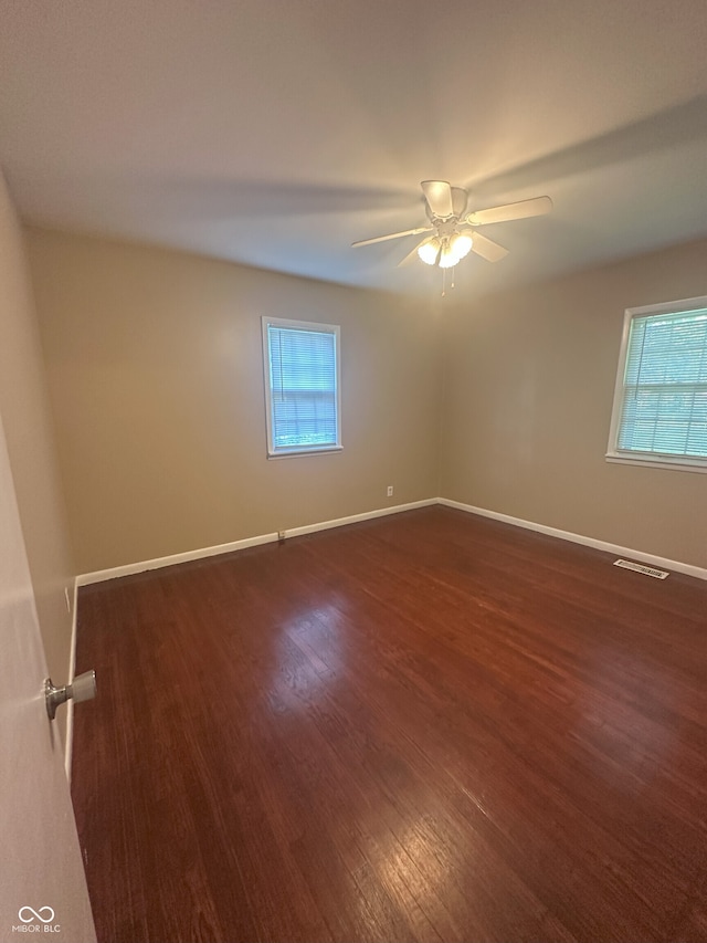 2180 N Irwin St, Indianapolis, IN 46219 - empty room with wood finished floors, healthy amount of natural light, a ceiling fan, and baseboards