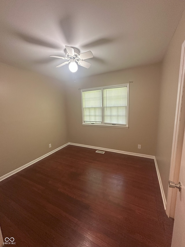 2180 N Irwin St, Indianapolis, IN 46219 - spare room with a ceiling fan, dark wood-type flooring, and baseboards