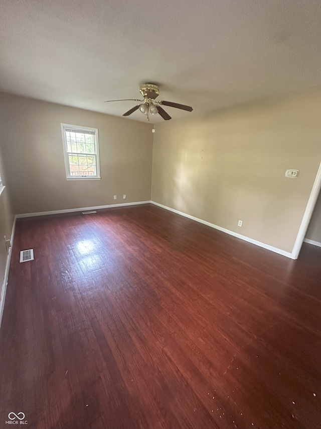 2180 N Irwin St, Indianapolis, IN 46219 - empty room featuring dark wood-style flooring, ceiling fan, and baseboards