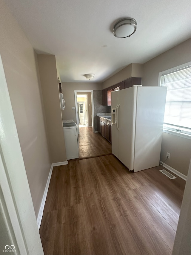 2180 N Irwin St, Indianapolis, IN 46219 - kitchen with white refrigerator with ice dispenser, dark wood-style floors, baseboards, and light countertops