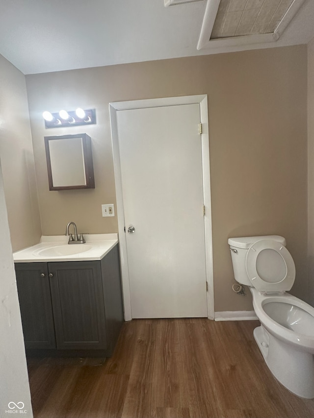 2180 N Irwin St, Indianapolis, IN 46219 - half bath featuring wood finished floors, toilet, vanity, and baseboards