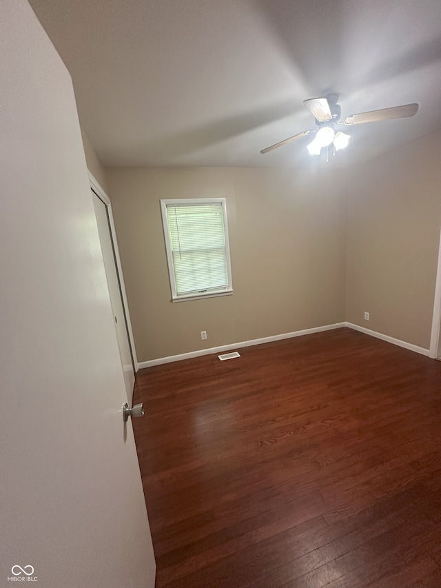 2180 N Irwin St, Indianapolis, IN 46219 - empty room with a ceiling fan, dark wood-type flooring, and baseboards