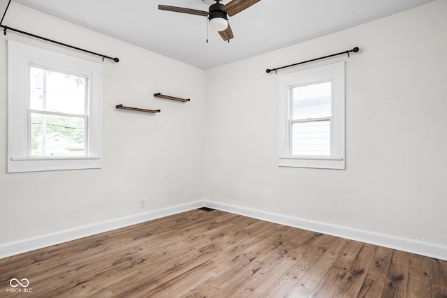 614 N Drexel Ave, Indianapolis, IN 46201 - unfurnished room featuring healthy amount of natural light, baseboards, wood-type flooring, and ceiling fan