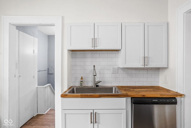 614 N Drexel Ave, Indianapolis, IN 46201 - kitchen with dishwasher, butcher block counters, a sink, tasteful backsplash, and white cabinets