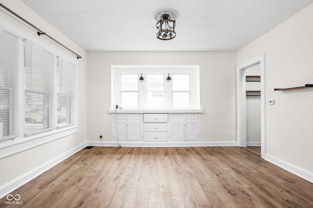 614 N Drexel Ave, Indianapolis, IN 46201 - unfurnished dining area featuring plenty of natural light, light wood-style flooring, and baseboards