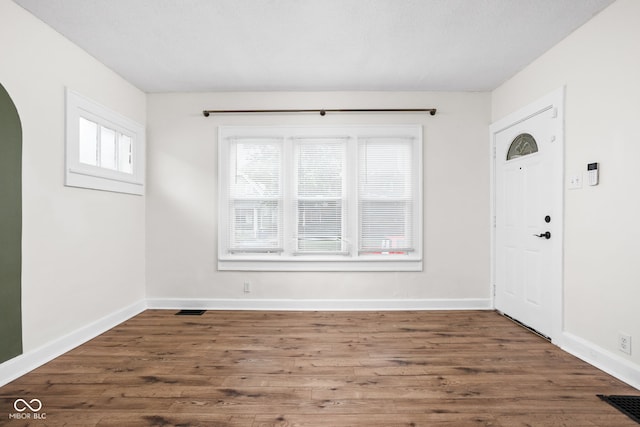 614 N Drexel Ave, Indianapolis, IN 46201 - entryway featuring arched walkways, wood finished floors, and baseboards