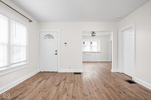 614 N Drexel Ave, Indianapolis, IN 46201 - foyer entrance with light wood-style floors and baseboards