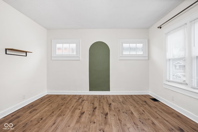 614 N Drexel Ave, Indianapolis, IN 46201 - spare room with hardwood / wood-style floors, baseboards, and arched walkways