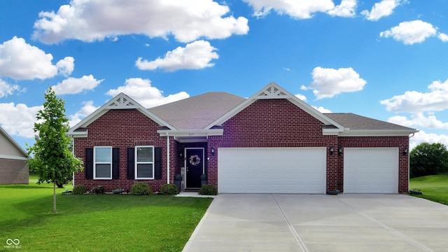 217 Saint Andrews Ave, Edinburgh, IN 46124 - view of front facade featuring concrete driveway, an attached garage, brick siding, and a front lawn