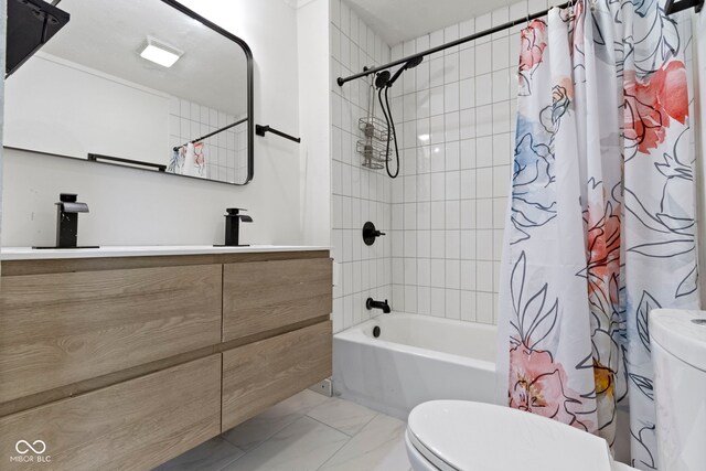 909 N Parker Ave, Indianapolis, IN 46201 - full bath featuring toilet, marble look tiles, vanity, and shower / bath combo