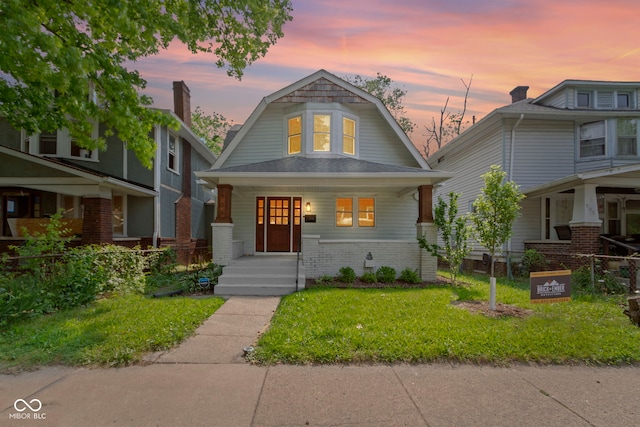 909 N Parker Ave, Indianapolis, IN 46201 - colonial inspired home with covered porch, a gambrel roof, and a front yard