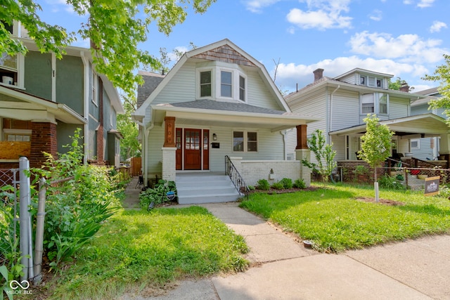 909 N Parker Ave, Indianapolis, IN 46201 - colonial inspired home with a porch, a shingled roof, and a gambrel roof