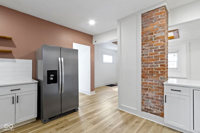 909 N Parker Ave, Indianapolis, IN 46201 - kitchen featuring stainless steel fridge with ice dispenser, baseboards, light countertops, and light wood finished floors