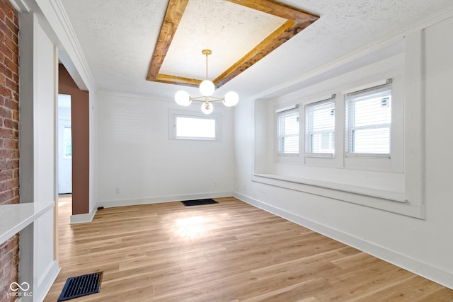 909 N Parker Ave, Indianapolis, IN 46201 - unfurnished dining area with a textured ceiling, a raised ceiling, ornamental molding, light wood-style floors, and baseboards
