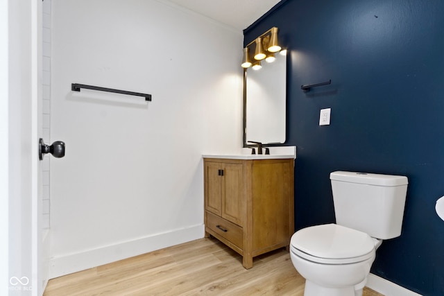 909 N Parker Ave, Indianapolis, IN 46201 - bathroom featuring vanity, toilet, wood finished floors, baseboards, and crown molding
