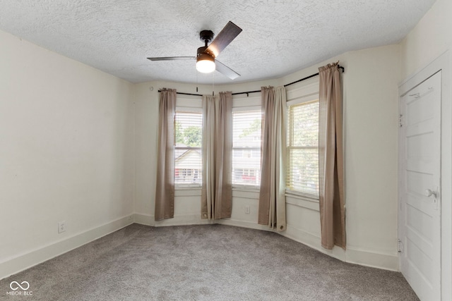 909 N Parker Ave, Indianapolis, IN 46201 - spare room with light colored carpet, a textured ceiling, ceiling fan, and baseboards