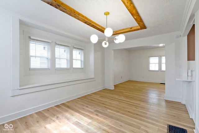 909 N Parker Ave, Indianapolis, IN 46201 - spare room featuring light wood finished floors, baseboards, a chandelier, ornamental molding, and a raised ceiling