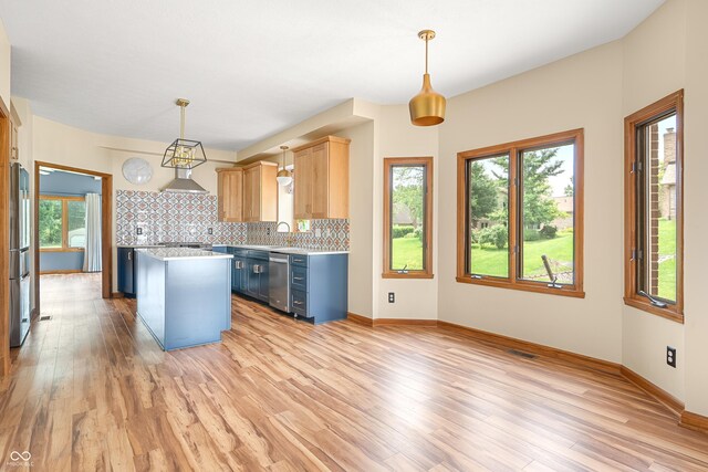 7082 Hunters Ridge Dr, Plainfield, IN 46168 - kitchen featuring appliances with stainless steel finishes, light countertops, light wood finished floors, and healthy amount of natural light