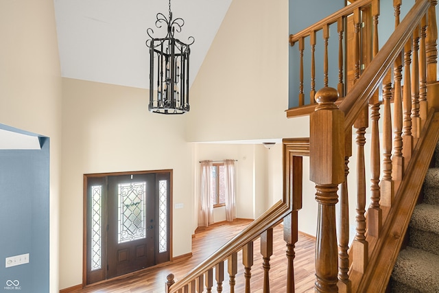 7082 Hunters Ridge Dr, Plainfield, IN 46168 - entryway with high vaulted ceiling, wood finished floors, a chandelier, and stairway