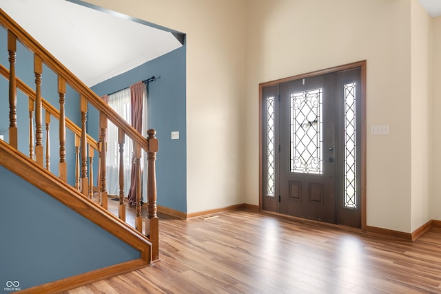 7082 Hunters Ridge Dr, Plainfield, IN 46168 - foyer entrance featuring a high ceiling, wood finished floors, and stairway