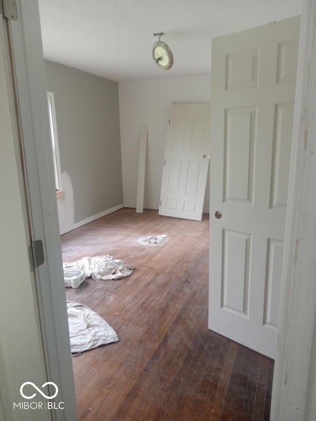 3626 N Denny St, Indianapolis, IN 46218 - empty room with dark wood-style floors and baseboards