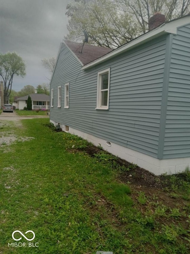 3626 N Denny St, Indianapolis, IN 46218 - view of home's exterior with a chimney and a lawn