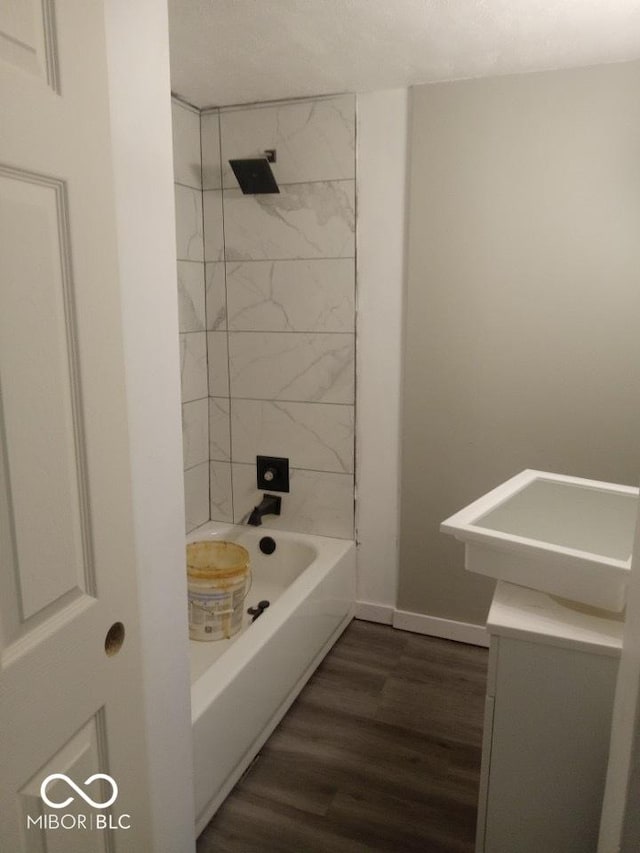 3626 N Denny St, Indianapolis, IN 46218 - full bathroom with wood finished floors, vanity, tub / shower combination, and baseboards