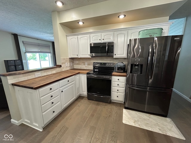 7195 W 700 N, Fairland, IN 46126 - kitchen with black appliances, butcher block counters, white cabinetry, tasteful backsplash, and dark wood-style floors
